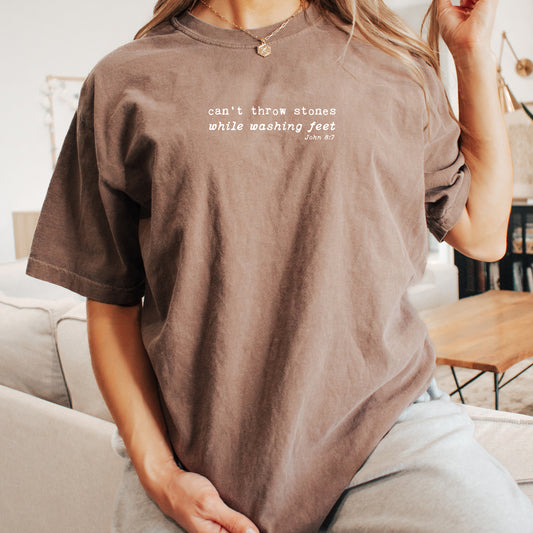 CAN'T THROW STONES WHILE WASHING FEET UNISEX TEE IN ESPRESSO - SIZE MEDIUM