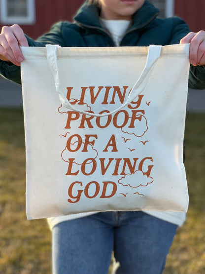 LIVING PROOF OF A LOVING GOD TOTE BAG